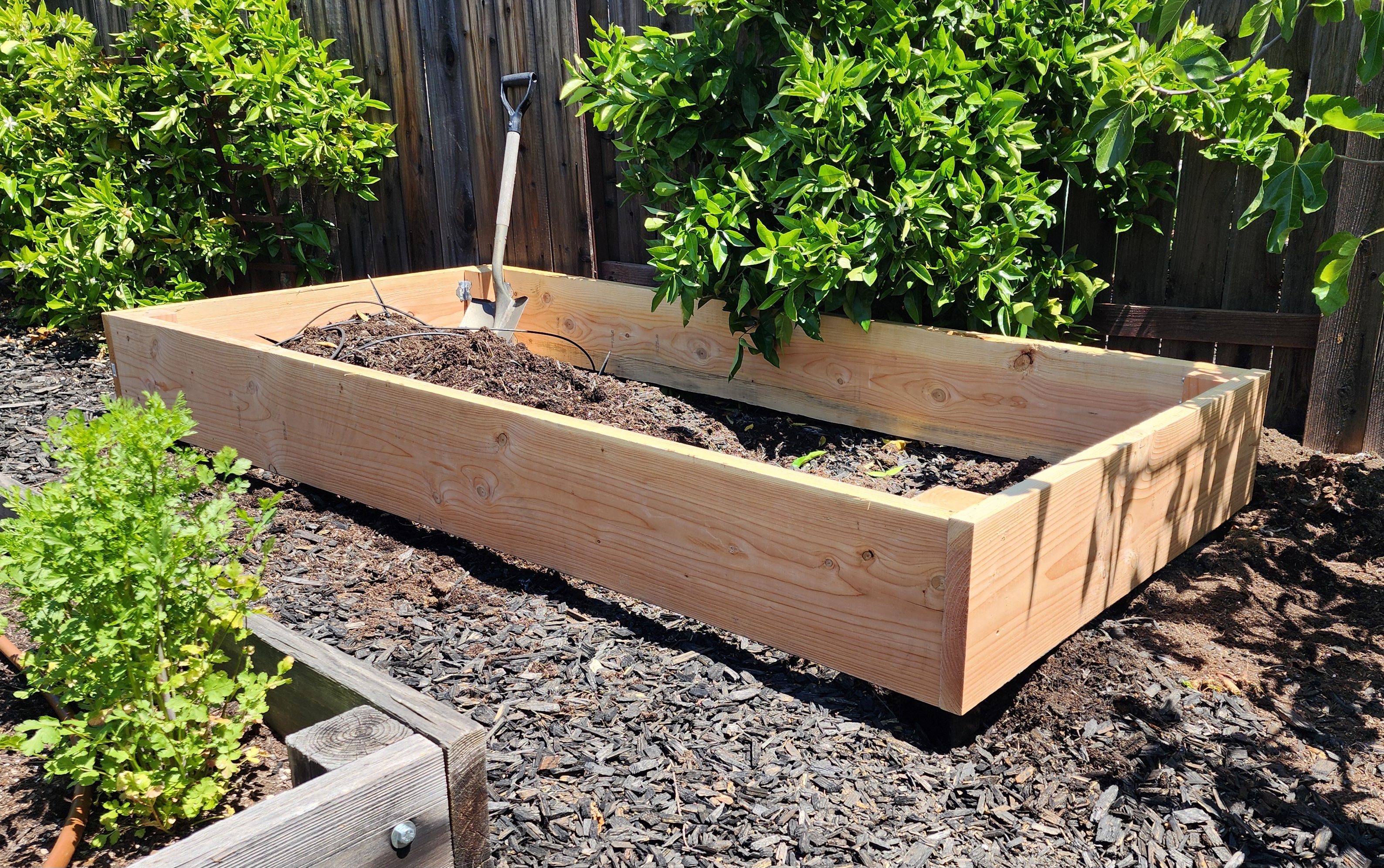 Compact 12-inch cedar beds staged on gravel