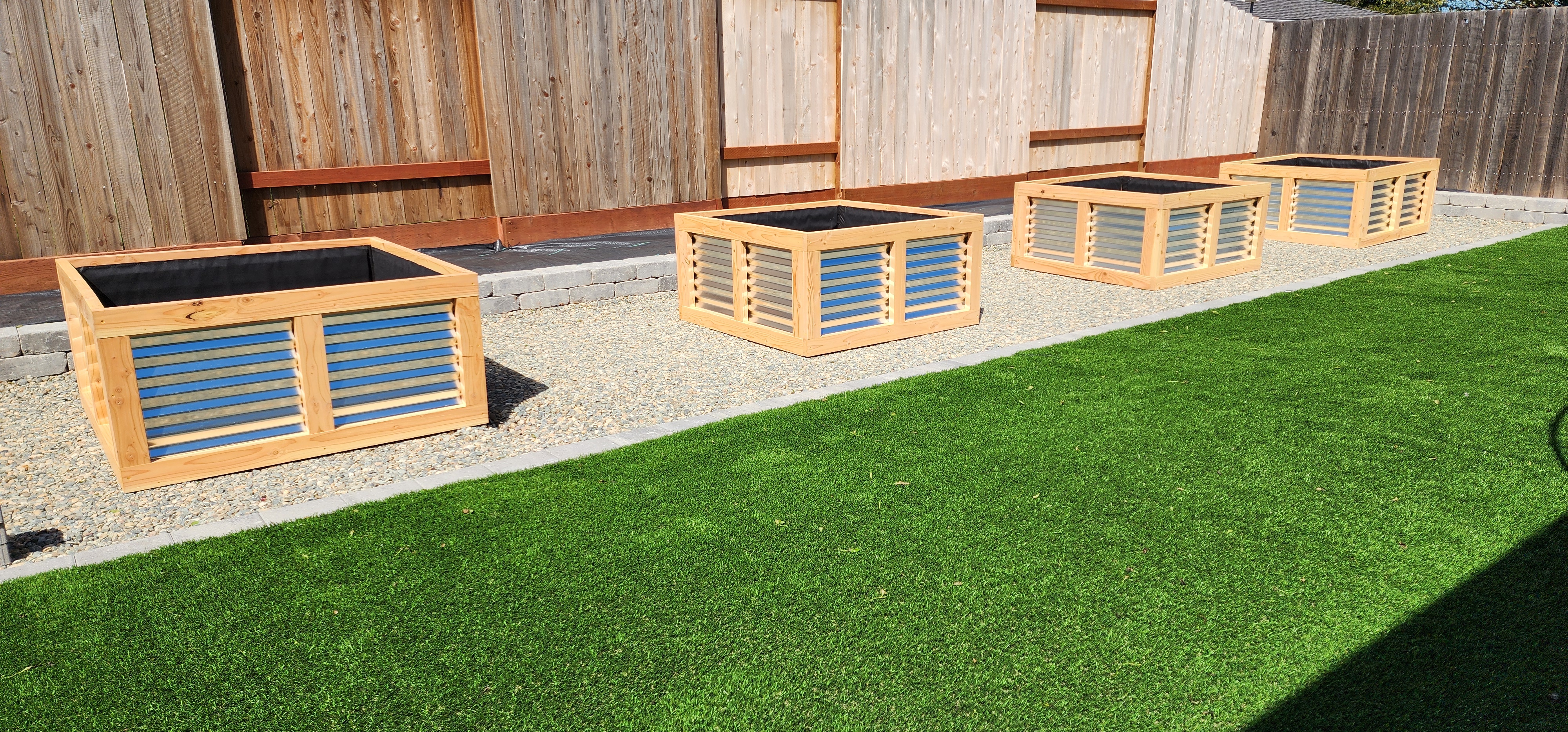 Arrangement of square four-by-four planters on decomposed granite