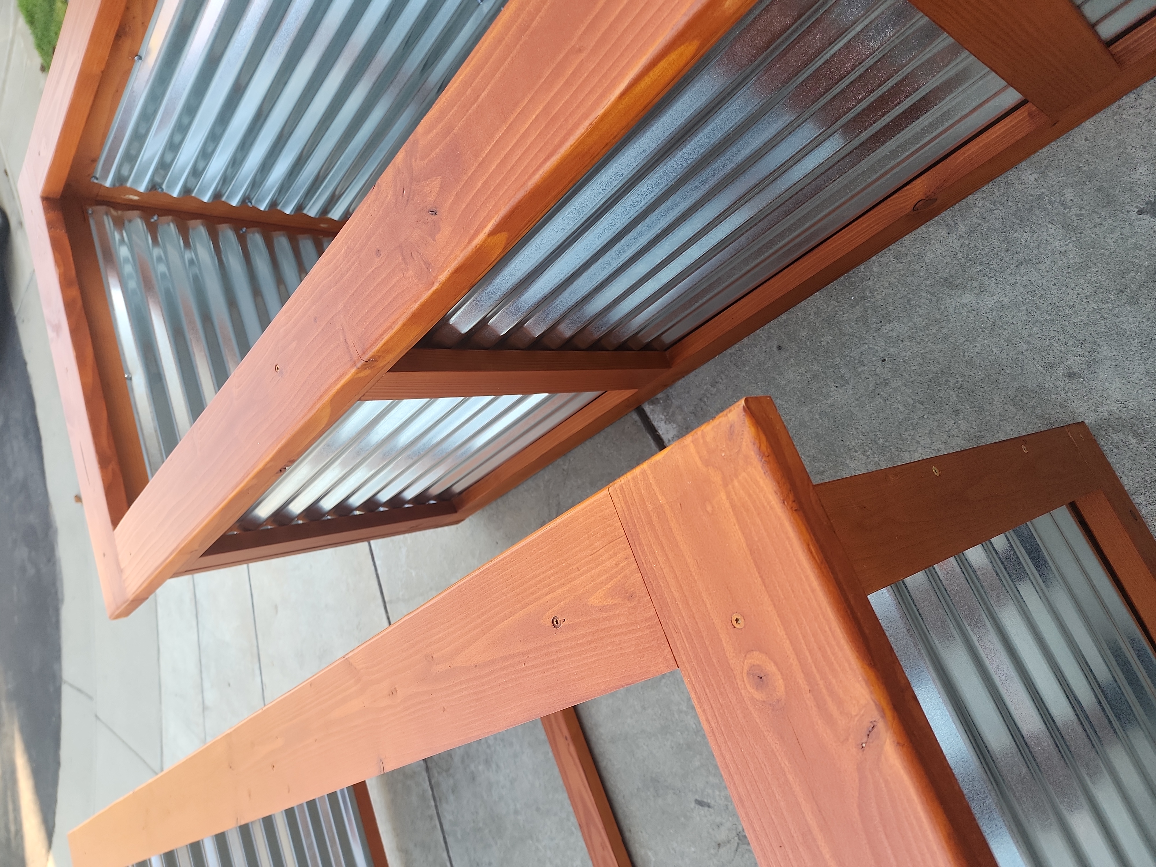 Close-up of a stained top rail on a planter
